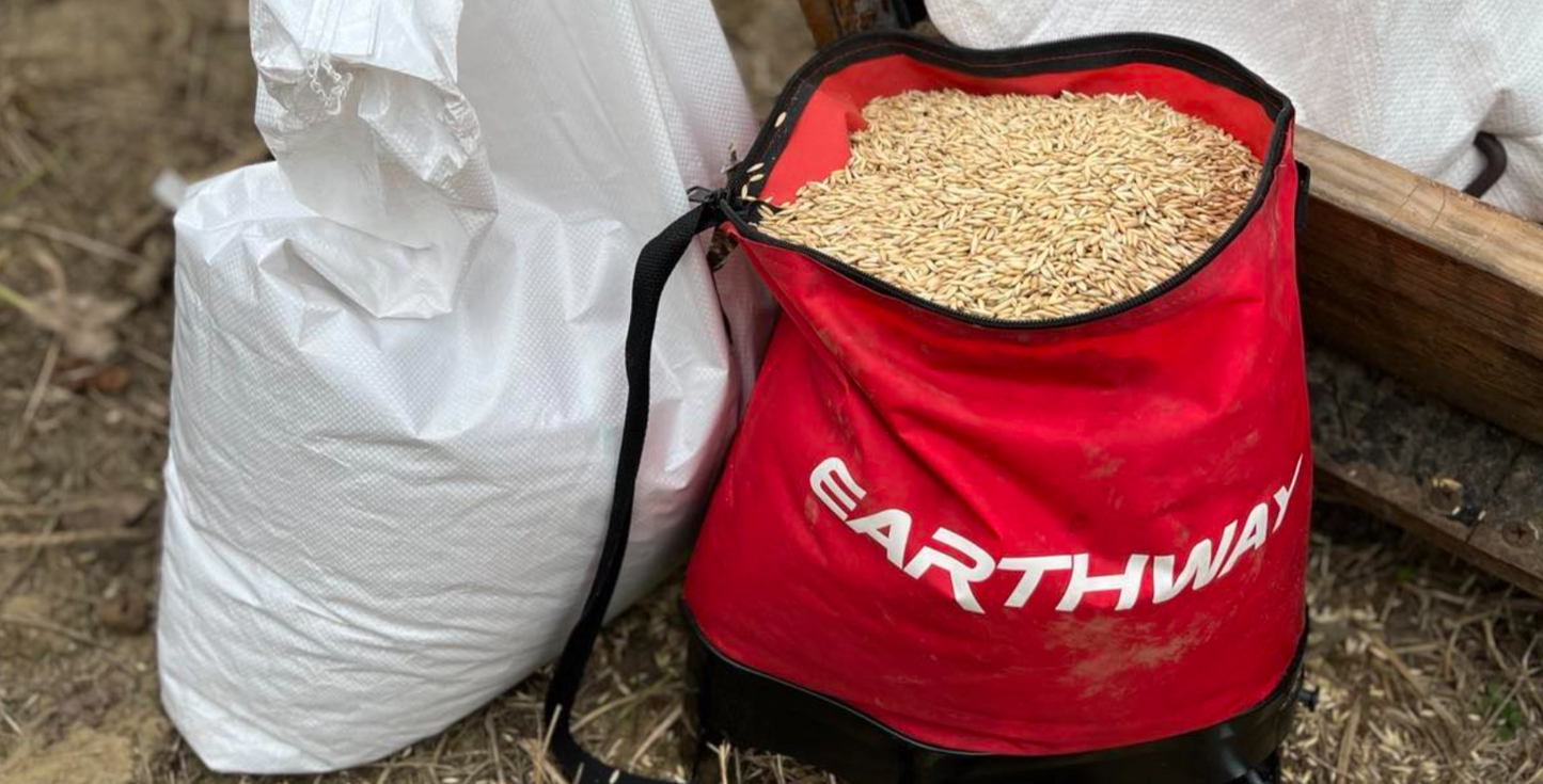Red Earthway bag filled with grain on a farm setting